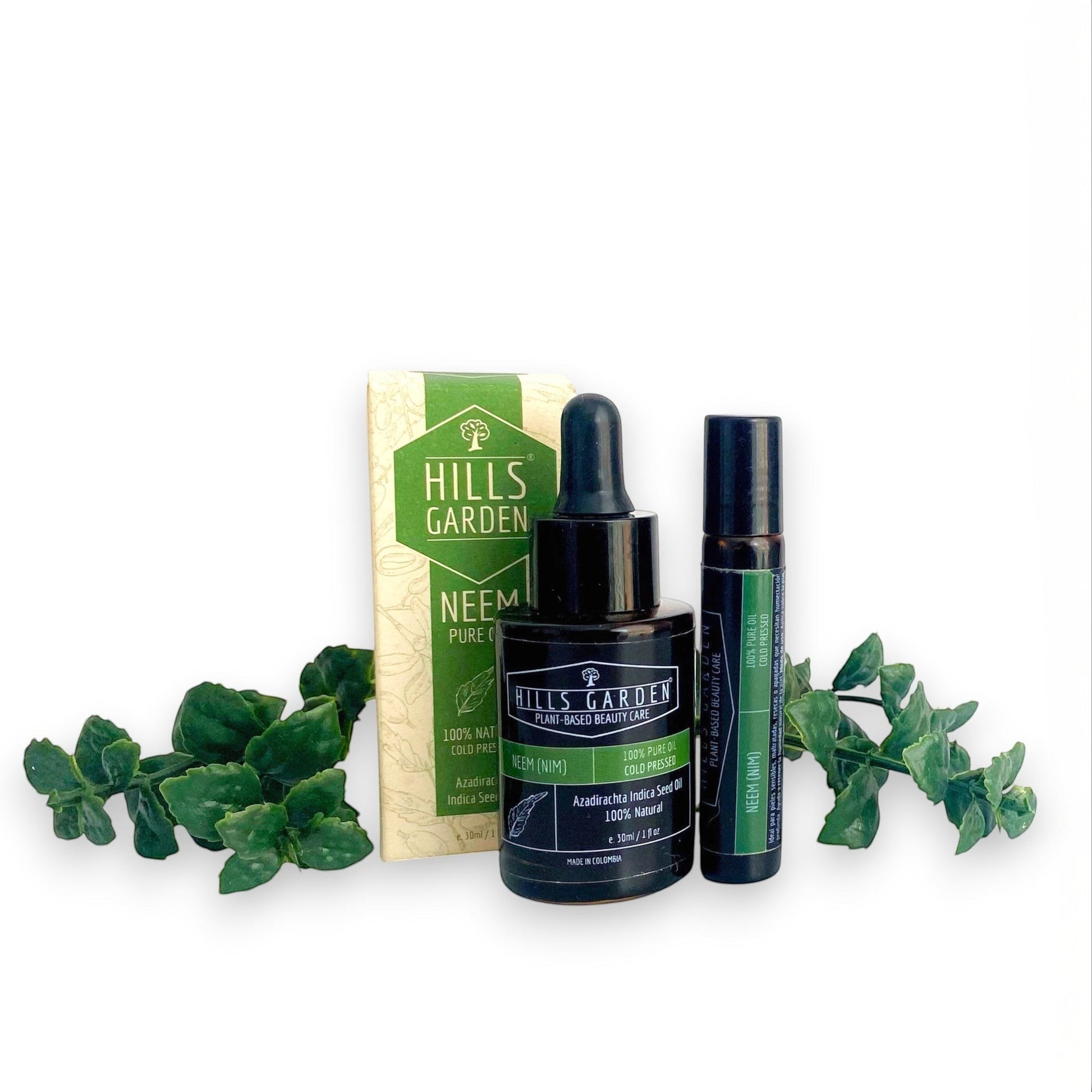 Aceite puro de neem HILLS GARDEN prensado en frío en frasco con gotero y envase roll-on junto a su caja original.
